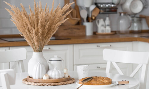 A warm, inviting kitchen counter with soft morning light, a sliced loaf of pumpkin bread, and a simple ceramic plate.